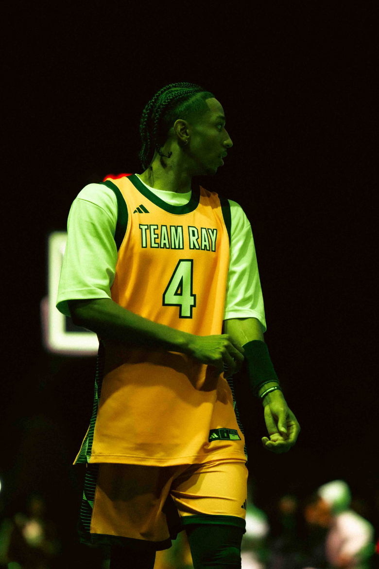 Trey Phills playing basketball represented by Raymond Representation.